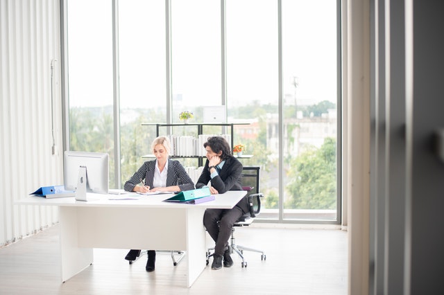 Two property managers looking at notes in an office